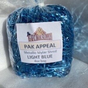 May include: A 40 oz bag of light blue metallic mylar shred, labeled "PAK APPEAL Metallic Mylar Shred Light Blue 40 oz bag".