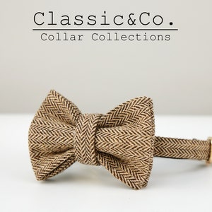 May include: A brown and black herringbone bow tie with a matching collar. The collar has a gold metal buckle. Classic & Co. Collar Collections.