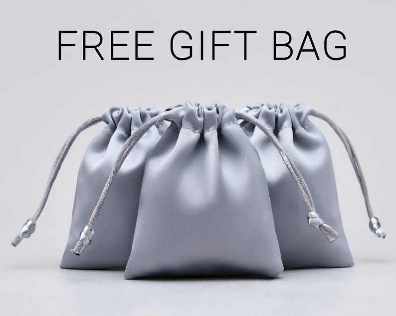 May include: Three silver satin drawstring bags with white cords. FREE GIFT BAG.