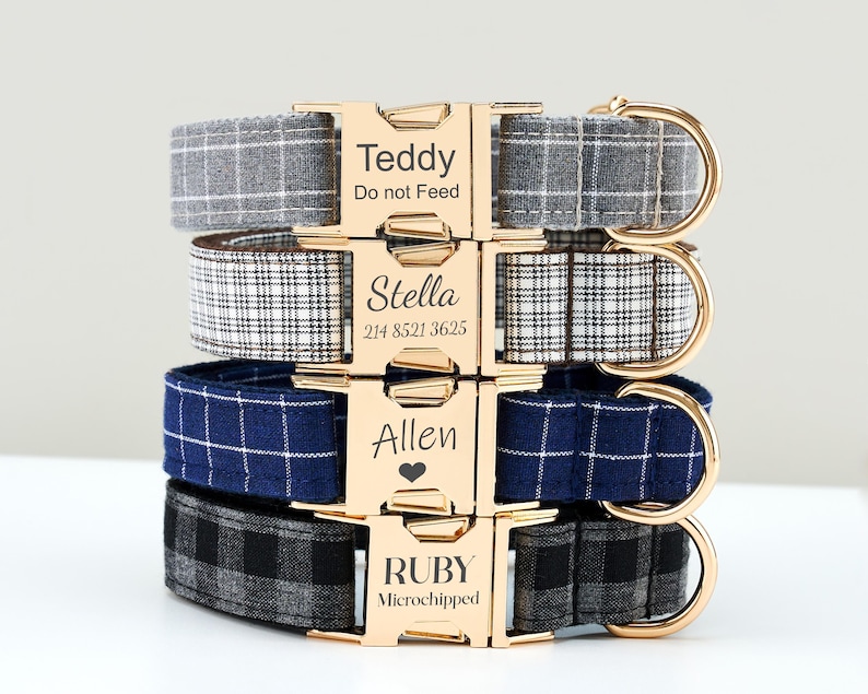 May include: Four personalized dog collars stacked, each with a gold buckle and a different plaid pattern. The collars are gray, black and white, navy blue, and black and gray. Each buckle is engraved with a name and additional text.