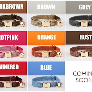 May include: Nine different color cat collars with a gold buckle and bell. The colors are dark brown, brown, grey, hot pink, orange, rust, wine red, blue, and coming soon.