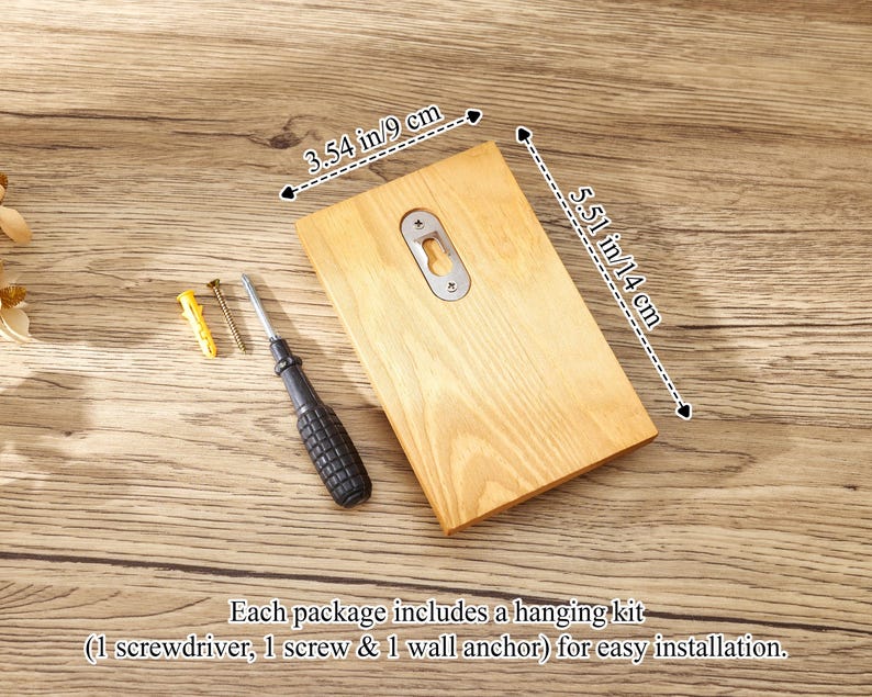 May include: A rectangular light-colored wooden plaque with a metal keyhole hanger on the back. The plaque measures 3.54 inches by 5.51 inches. Included are a small screwdriver, a metal screw, and a yellow plastic wall anchor for installation.