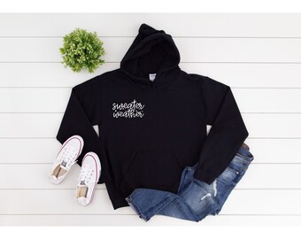 May include: Black hooded sweatshirt with the text "sweater weather" in white script on the front pocket.