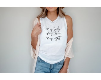 May include: White sleeveless tank top with the text "my body my choice my rights" written in black cursive with a heart symbol before each word.
