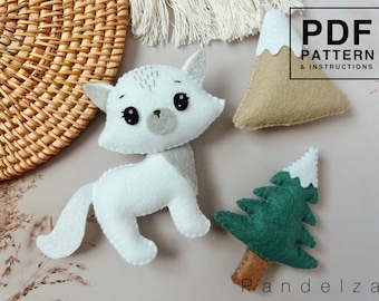May include: A PDF pattern and instructions for making felt animal toys. The pattern includes a white cat, a green tree with a white top, and a brown mountain with a white top.