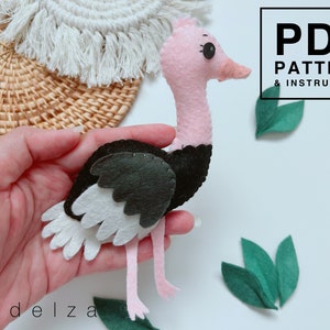 May include: A felt ostrich toy with pink legs, a black body, and white wings. The toy is being held in a hand. The image also includes the text "PDF PATTERN & INSTRUCTION".