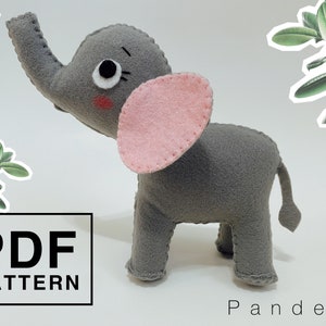 May include: A gray felt elephant toy with pink felt ears and a white felt eye. The toy is standing on a white surface. The text "PDF PATTERN" is visible in the lower left corner of the image.