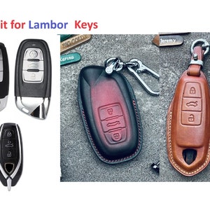 May include: Three different car key fobs, two are black and one is silver. The black key fobs have four buttons and a black leather key fob case with red stitching. The silver key fob has four buttons and a brown leather key fob case with tan stitching. The text "Fit for Lambor Keys" is at the top of the image.