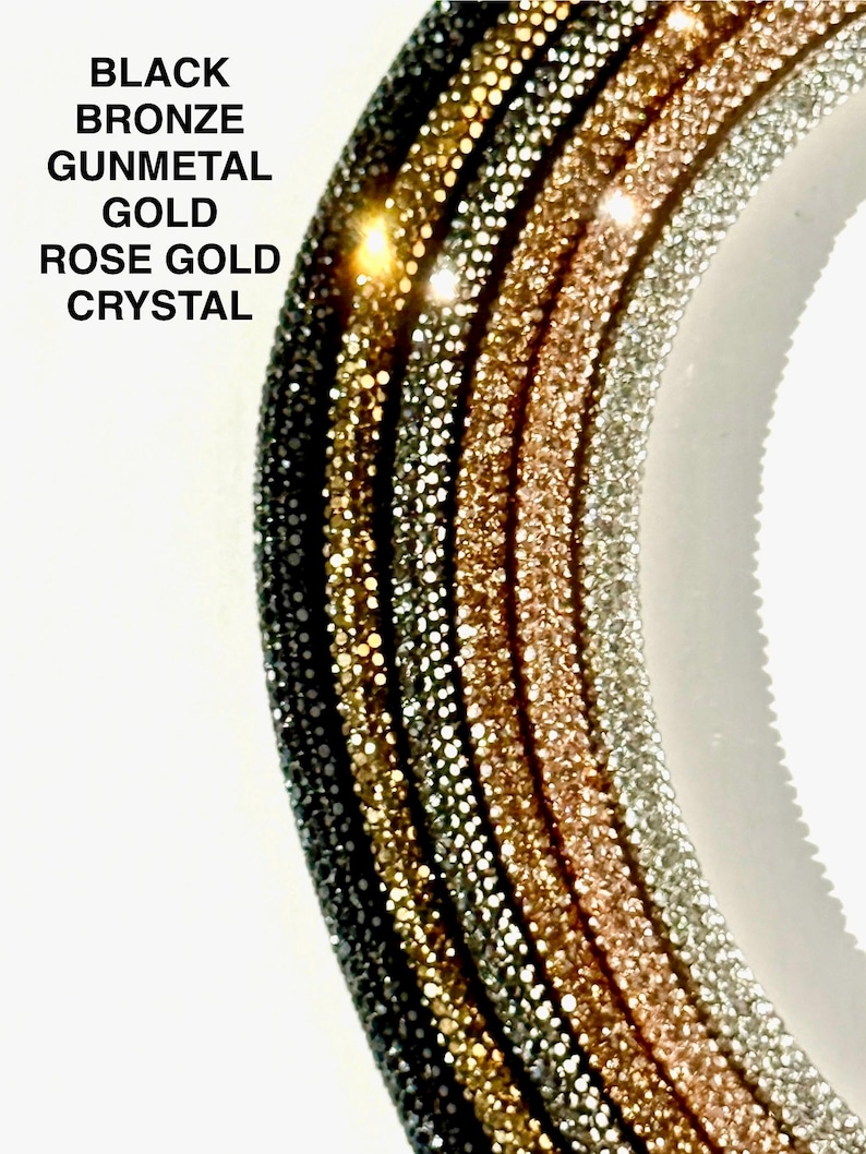 May include: Five different colored rhinestone chains, from left to right: black, bronze, gunmetal, gold, and rose gold. The chains are arranged in a semi-circle.