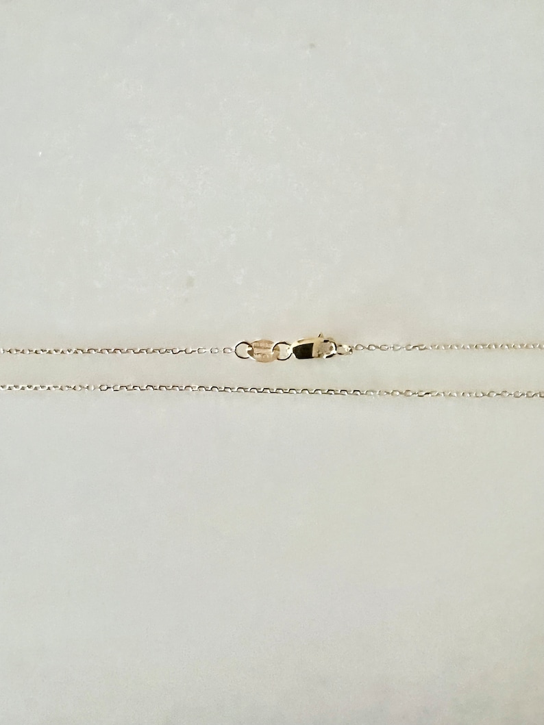 May include: A gold chain necklace with a lobster clasp closure.