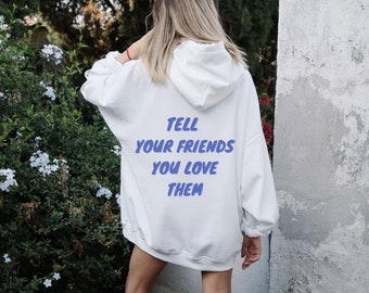 May include: White hooded sweatshirt with the text "TELL YOUR FRIENDS YOU LOVE THEM" printed in blue on the back.