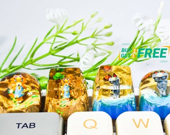 May include: Four resin keycaps featuring characters from the Animal Crossing video game series. The keycaps are clear and show the characters in different scenes. The keycaps are on a white keyboard with the keys "TAB", "Q", "W", "E", "CAPSLOCK", "A", "S" visible.