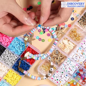 May include: A colourful set of beads and charms in a clear plastic container. The beads are organised by colour and type, and include letters, stars, shells, and circles. The container is labelled "Discovery Trading Limited".