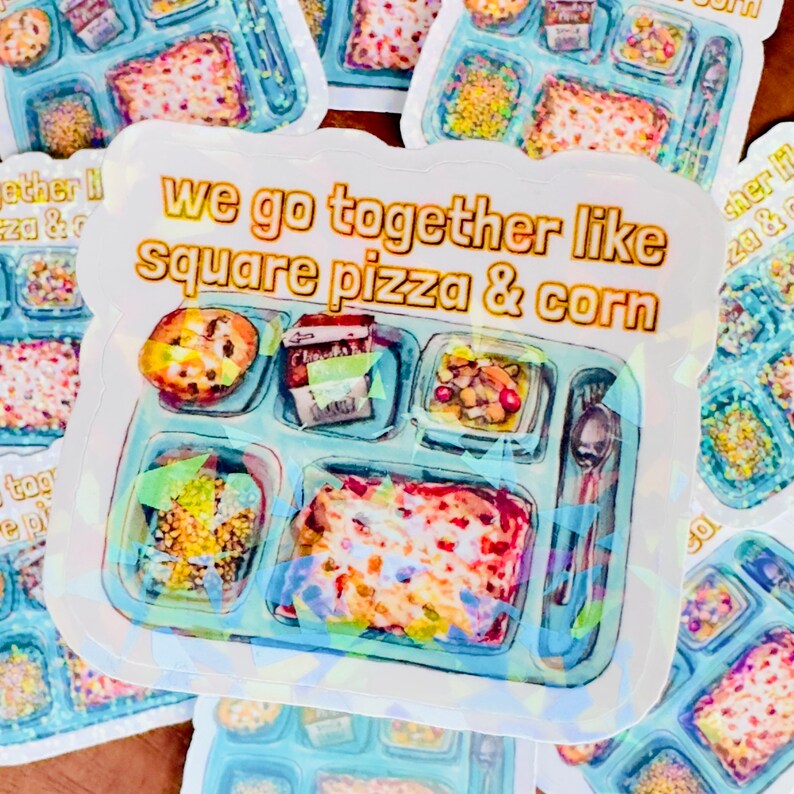 May include: A sticker with a blue and white illustration of a school lunch tray with square pizza, corn, and other food items. The text "We go together like square pizza & corn" is written in gold letters on the sticker.