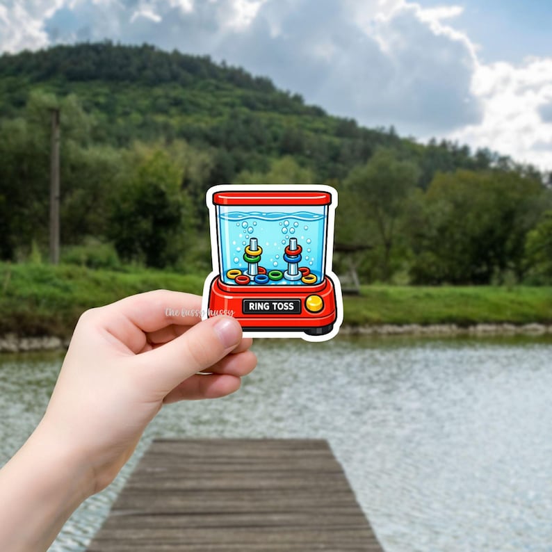 Colorful cartoon sticker of a retro, handheld water ring toss game