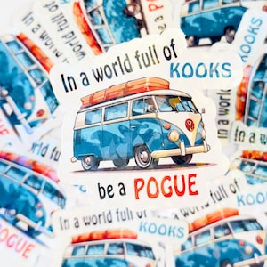 May include: A sticker with a blue and white Volkswagen van with surfboards on top. The sticker says "In a world full of Kooks be a Pogue".
