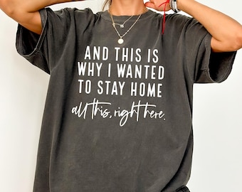 May include: A dark gray oversized t-shirt with the text "AND THIS IS WHY I WANTED TO STAY HOME all this, right here." printed in white.