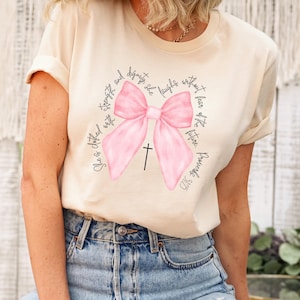 Proverbs 31:25 T-Shirt, She Is Clothed With Strength T Shirt, Coquette Bow Shirt, Bible Verse Shirt, Christian Girls Shirt, Religious Shirt