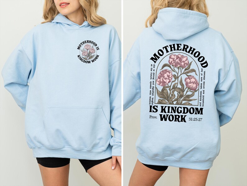 May include: Light blue hoodie with the text "MOTHERHOOD IS KINGDOM WORK" and a floral design on the front and back. The back design includes additional text and the Bible verse Proverbs 31:25-27.