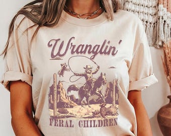 Funny Western Raccoon T-Shirt: Retro Wranglin' Feral Children Tee