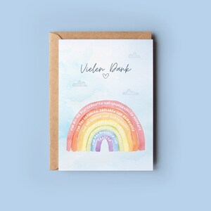Op de afbeelding: Een aquarel regenboogkaart met de tekst "Vielen Dank" en een hartje. De regenboog heeft woorden op elke kleurband geschreven, waaronder "Voor al het lachen" en "Voor het geduld".
