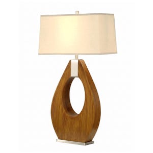 May include: A table lamp featuring a rectangular off-white fabric shade atop a teardrop-shaped wooden base with a visible grain pattern. The lamp includes a brushed metal accent piece at the top of the wooden cutout and a matching rectangular base.