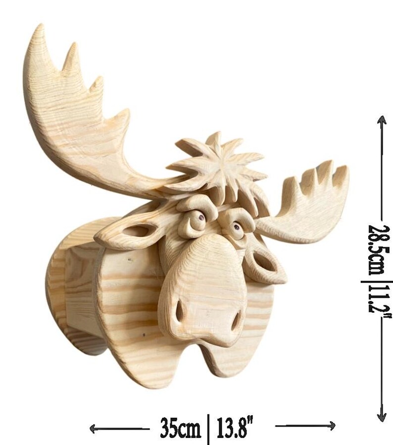 May include: A wooden moose head sculpture, featuring detailed carving and a natural wood finish. The sculpture measures 13.8 inches wide and 11.2 inches high. The moose has large antlers and a whimsical expression.