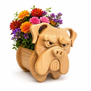 May include: A wooden bulldog planter filled with vibrant flowers. The planter is carved from light-colored wood, featuring the bulldog's face and a trough for plants. The flowers include orange, red, pink, and purple blooms, creating a colorful display.
