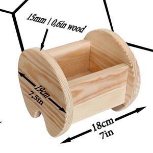 May include: A light-colored wooden desk organizer with a rectangular compartment and rounded end pieces. The organizer is 7 inches wide, 7.5 inches tall, and made of 0.6-inch thick wood. The design is simple and natural.