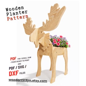 May include: A wooden moose-shaped planter, holding vibrant pink and purple flowers. The planter is made from light-colored wood and features the text "Wooden Planter Pattern". The design is available in PDF, SVG, and DXF files.
