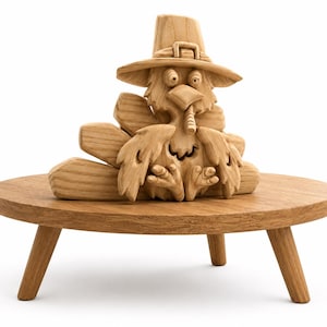May include: A wooden turkey figurine wearing a pilgrim hat, carved from light-colored wood. The turkey is perched on a small, round wooden table with three legs. The carving has detailed features and is set against a white background.