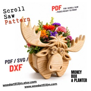 May include: A wooden moose-shaped planter filled with colorful flowers. The planter is carved from light-colored wood and features large antlers. Text on the image reads "Scroll Saw Pattern" and "Money Box & Planter".