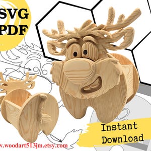 May include: A light-colored wooden reindeer-shaped organizer with large eyes, antlers, and a hollow back section. The image includes text reading SVG, PDF, and Instant Download, along with a line drawing of the reindeer and a website URL.