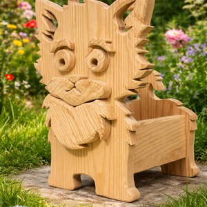 May include: A handcrafted wooden dog-shaped planter. The planter is made of light-colored wood and features a carved face with large eyes, a nose, and a beard. The dog has a box-like body and is sitting on a stone surface, surrounded by greenery.