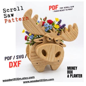May include: A wooden moose-shaped planter filled with colorful flowers. The planter is made from light-colored wood and features a detailed design. Text on the image reads "Scroll Saw Pattern" and "Money Box & Planter".