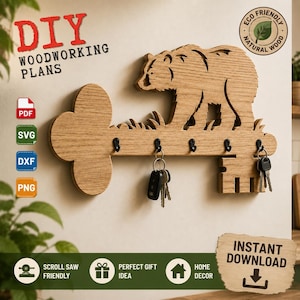 May include: A light brown wooden key-shaped wall hook rack featuring a cutout bear silhouette standing on grass. The rack includes five black metal hooks, with two sets of keys hanging from them. Text includes DIY WOODWORKING PLANS, PDF, SVG, DXF, PNG, and INSTANT DOWNLOAD.