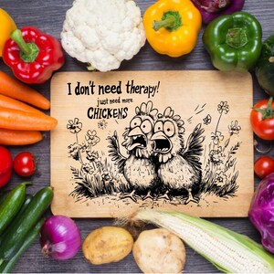 May include: A wooden chopping board with a humorous illustration of two chickens and the text "I don't need therapy! Just need more chickens."