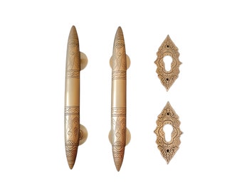 May include: Two ornate gold door handles with intricate designs and matching keyhole covers.