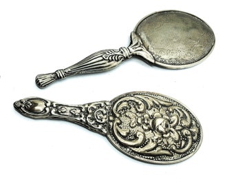 A pair of Antique Sterling Silver Mirror embossed with intricate designs