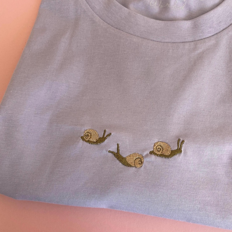 Snail T-Shirt with snails embroidered.
