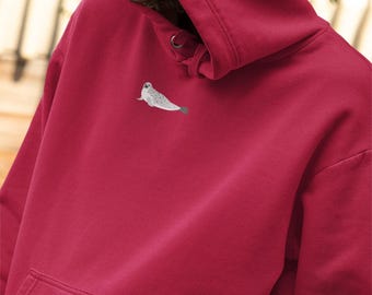 May include: A red hooded sweatshirt with a small embroidered image of a seal on the front.