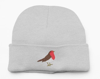 May include: A gray knitted beanie with a red-breasted robin embroidered on the front.