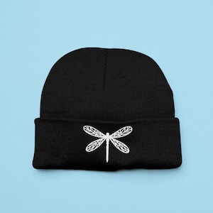 May include: Black beanie with a white embroidered dragonfly design.