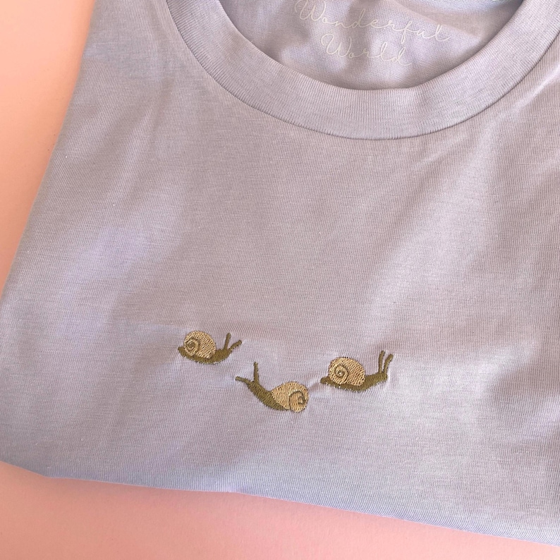 Snail T-Shirt with snails embroidered.