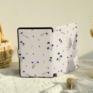 May include: A white and blue floral patterned e-reader case with a black e-reader inside.