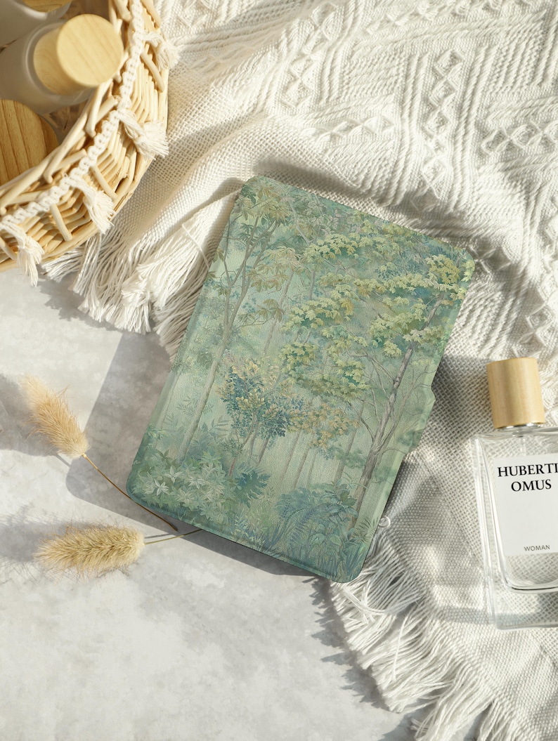 May include: A green and blue book cover with a forest scene. The cover has a textured, watercolor-like design with trees and foliage.