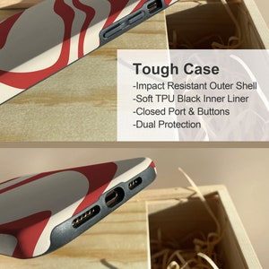 May include: A white and red phone case with a wavy pattern. The case is made of a tough material and has a black inner liner. The case has closed ports and buttons for added protection. Tough Case - Impact Resistant Outer Shell - Soft TPU Black Inner Liner - Closed Port & Buttons - Dual Protection
