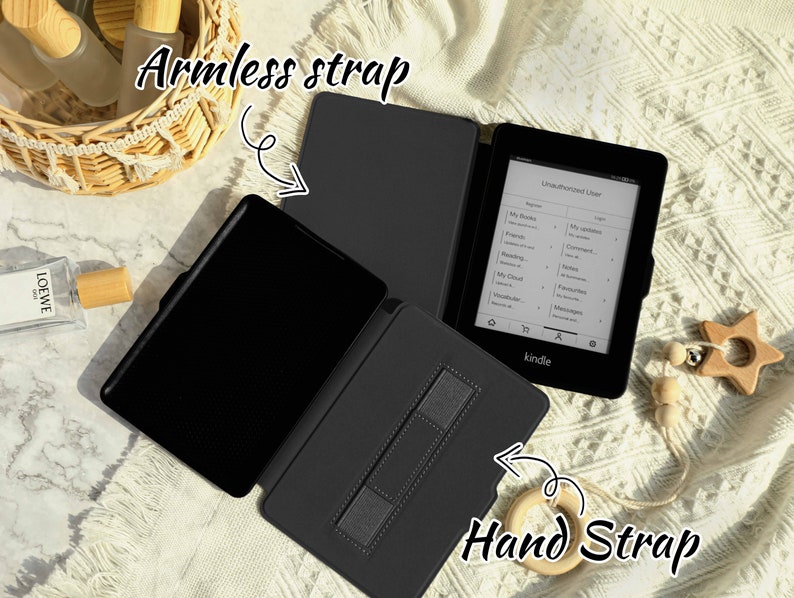 May include: Black Kindle e-reader with a black case. The case has a strap on the back for holding the e-reader and a strap on the side for holding the e-reader in your hand.