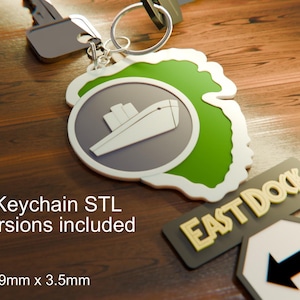 May include: A keychain with a green and white outline, featuring a ship graphic inside a gray circle. The keychain is attached to a key. The text "East Dock Keychain STL" is visible. The keychain measures 2.5 x 4.7 x 0.1 inches.