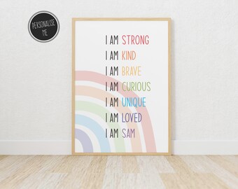 May include: A framed print with a rainbow design and the text "I am strong, I am kind, I am brave, I am curious, I am unique, I am loved, I am [Name]"